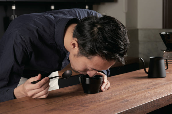 Tetsu Kasuya smelling coffee in a KCB-260-B Cupping Bowl Kasuya Model by Hario